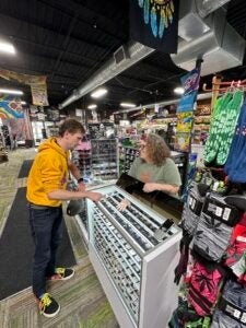 Ginny Saville, owner of The Botany Bay smoke shops in Lexington and Richmond, serves a customer. 